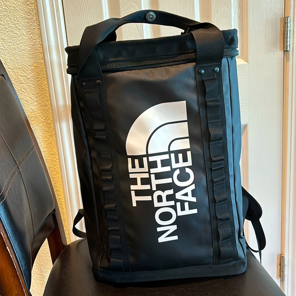 North Face unisex backpack in black, used with some minor flaws
